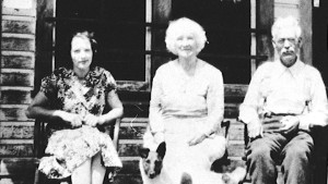 Edna Daney (nee Lindholm), Elizabeth Jowett, and John Simpson on the porch of the Windsor Hotel at Trout Lake City, ca. 1930s.